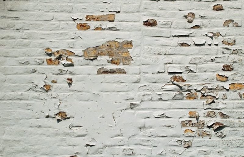 scrape away loose paint from brick first