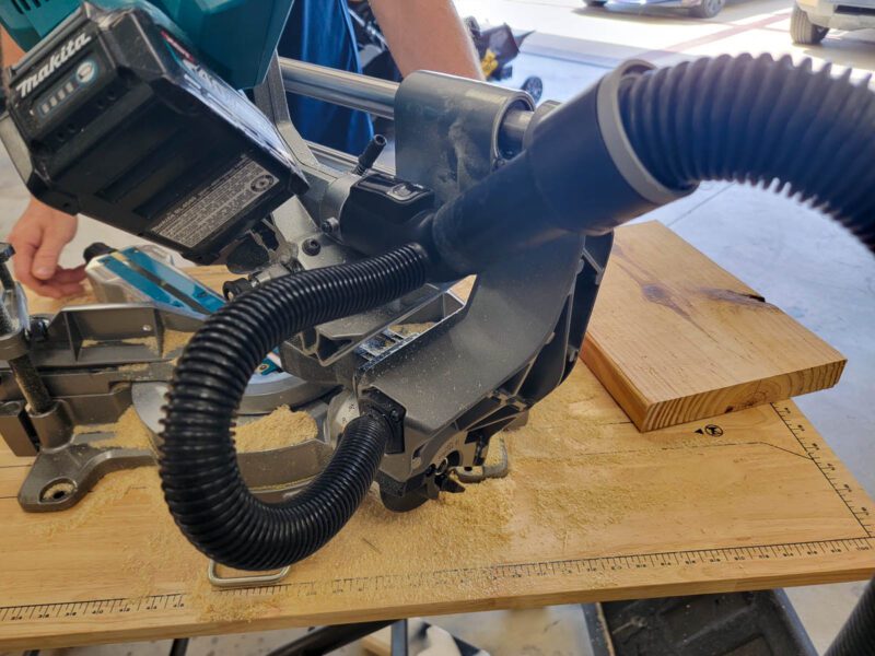 Dust collection hose and vacuum port